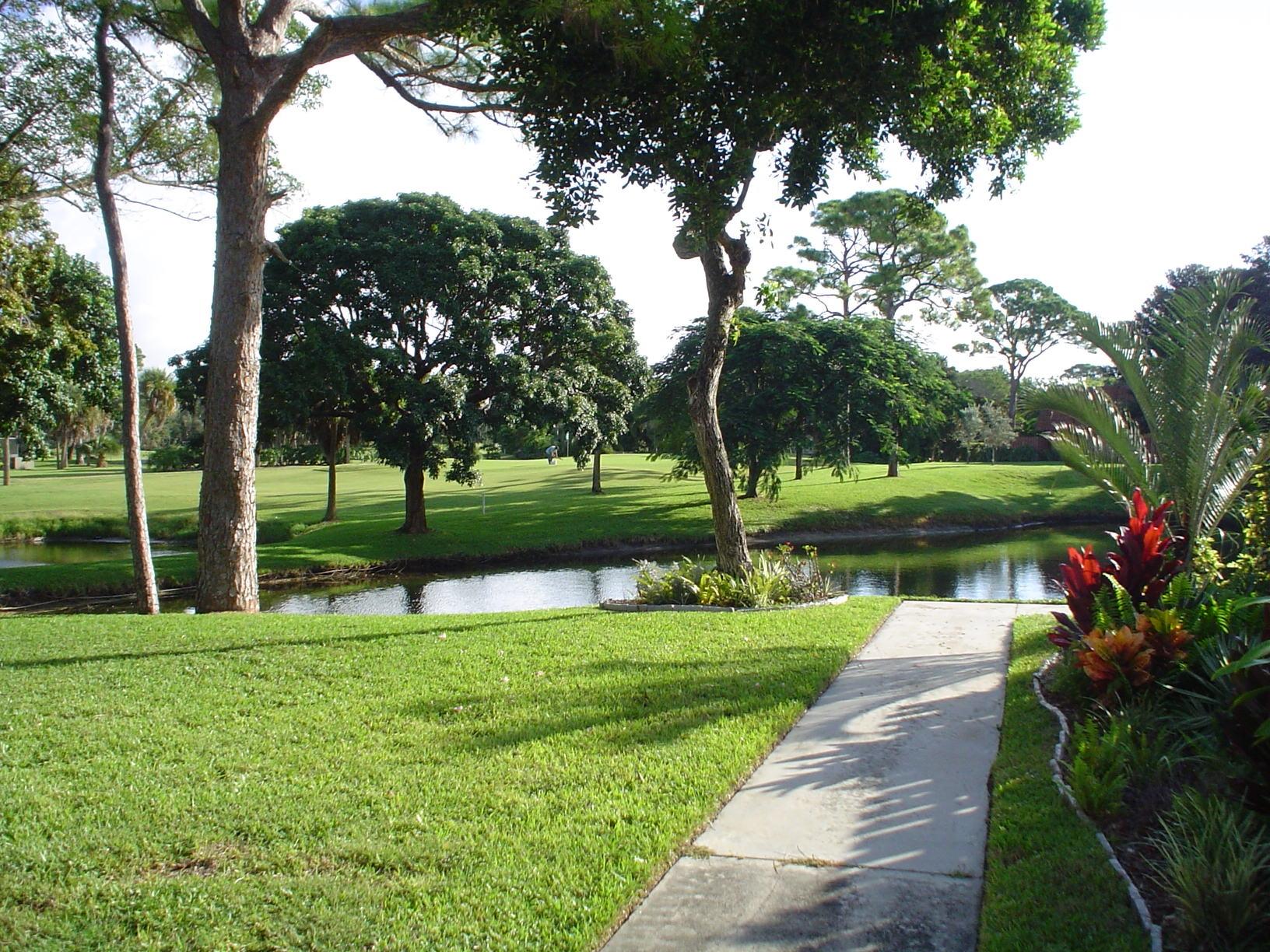 1445 Masters Circle, Unit 157 Delray Beach, FL 33445 - Photo 1 of 23 a view of lake with green space