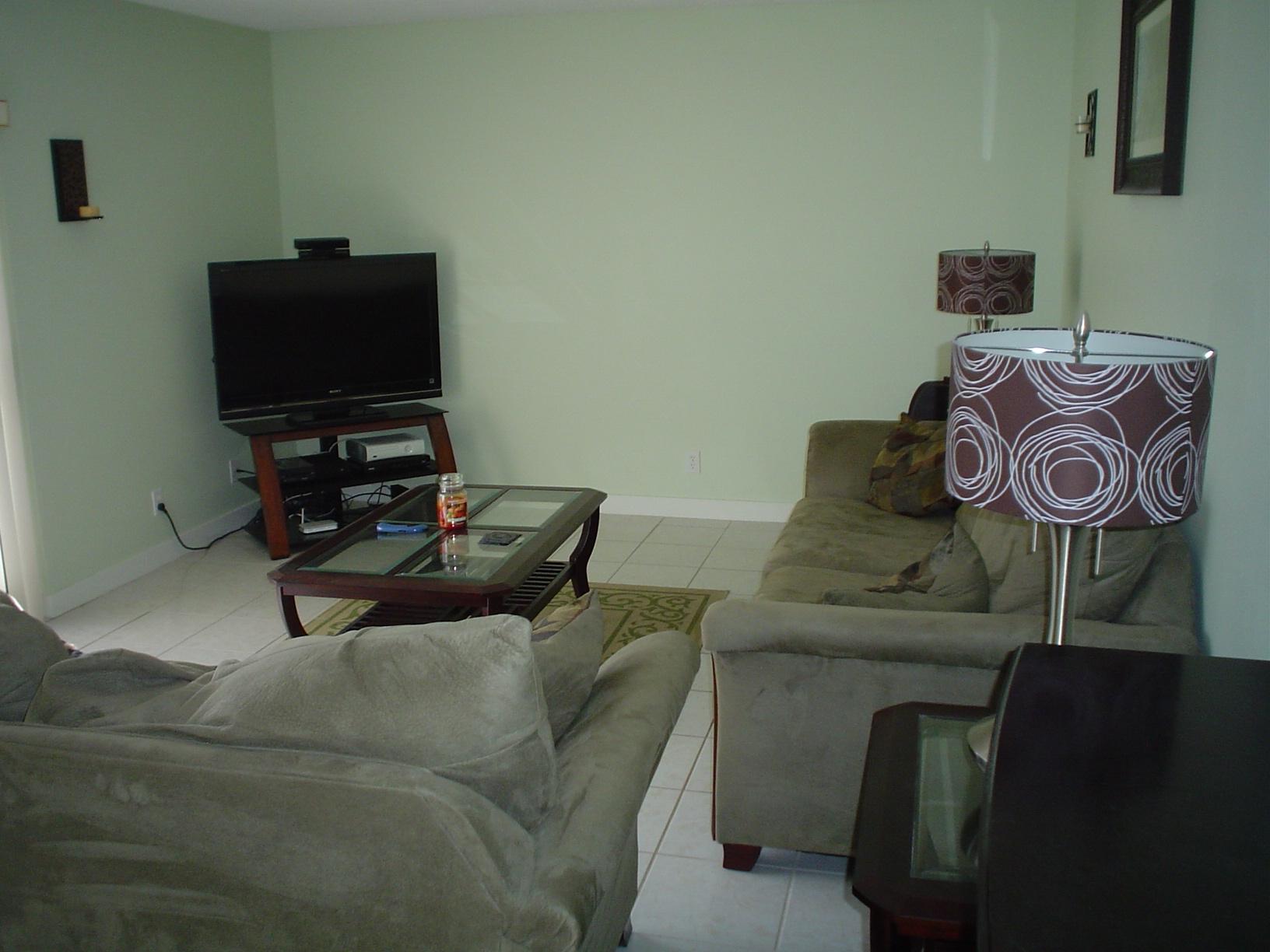 1445 Masters Circle, Unit 157 Delray Beach, FL 33445 - Photo 11 of 23 a living room with furniture and a flat screen tv