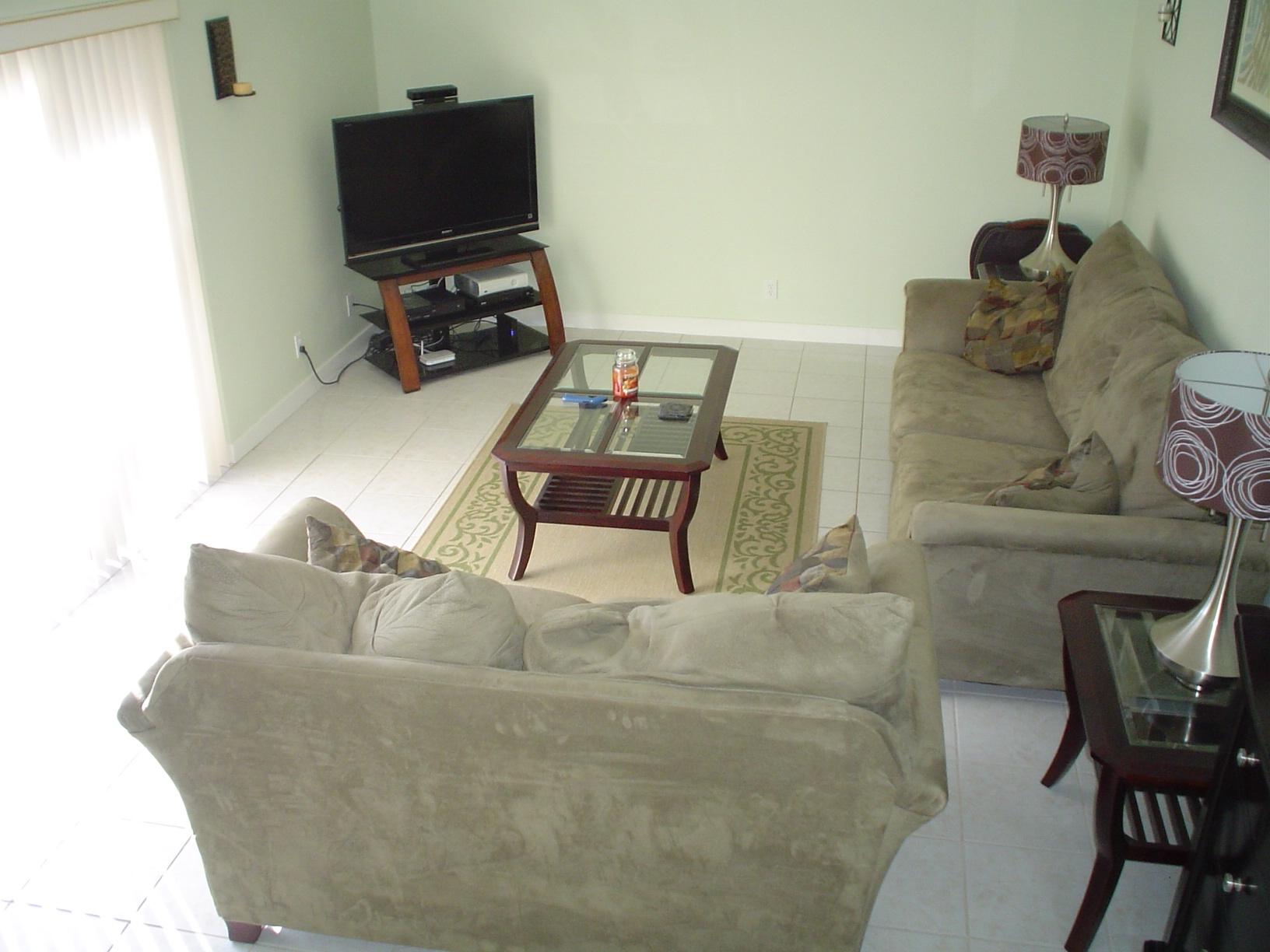 1445 Masters Circle, Unit 157 Delray Beach, FL 33445 - Photo 13 of 23 a living room with furniture and a flat screen tv