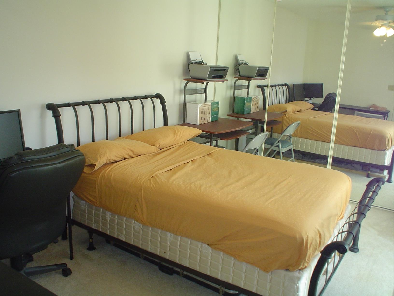 1445 Masters Circle, Unit 157 Delray Beach, FL 33445 - Photo 14 of 23 a bed sitting in a bedroom next to a window