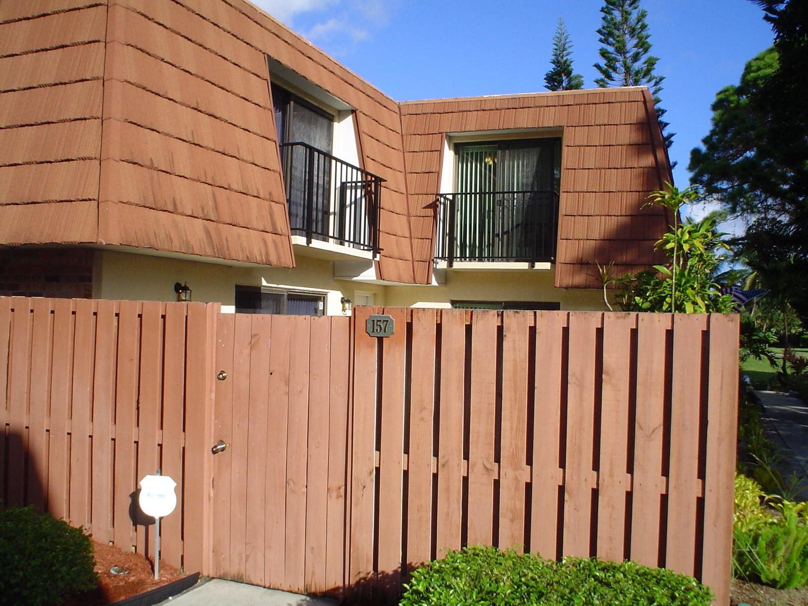 1445 Masters Circle, Unit 157 Delray Beach, FL 33445 - Photo 2 of 23 a front view of a house with a garden