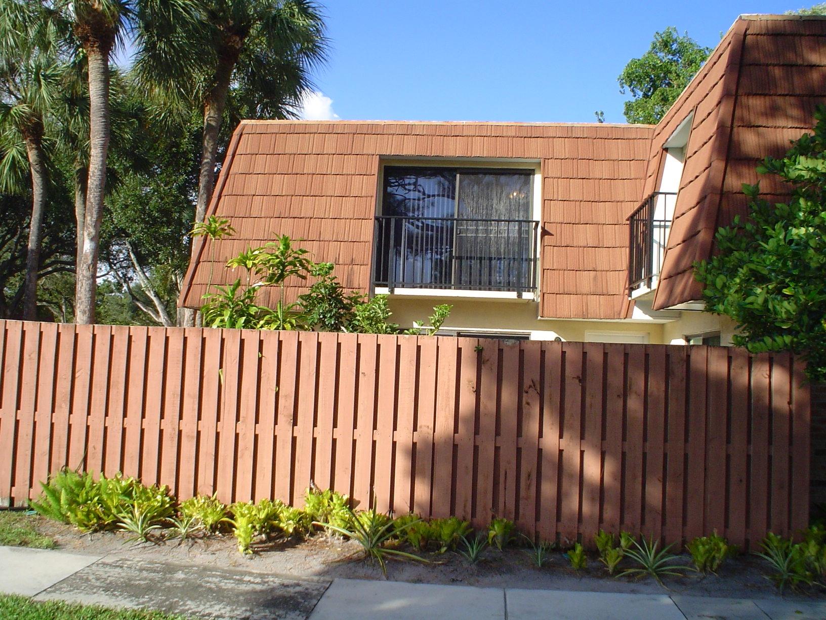 1445 Masters Circle, Unit 157 Delray Beach, FL 33445 - Photo 3 of 23 a front view of a house with a garden