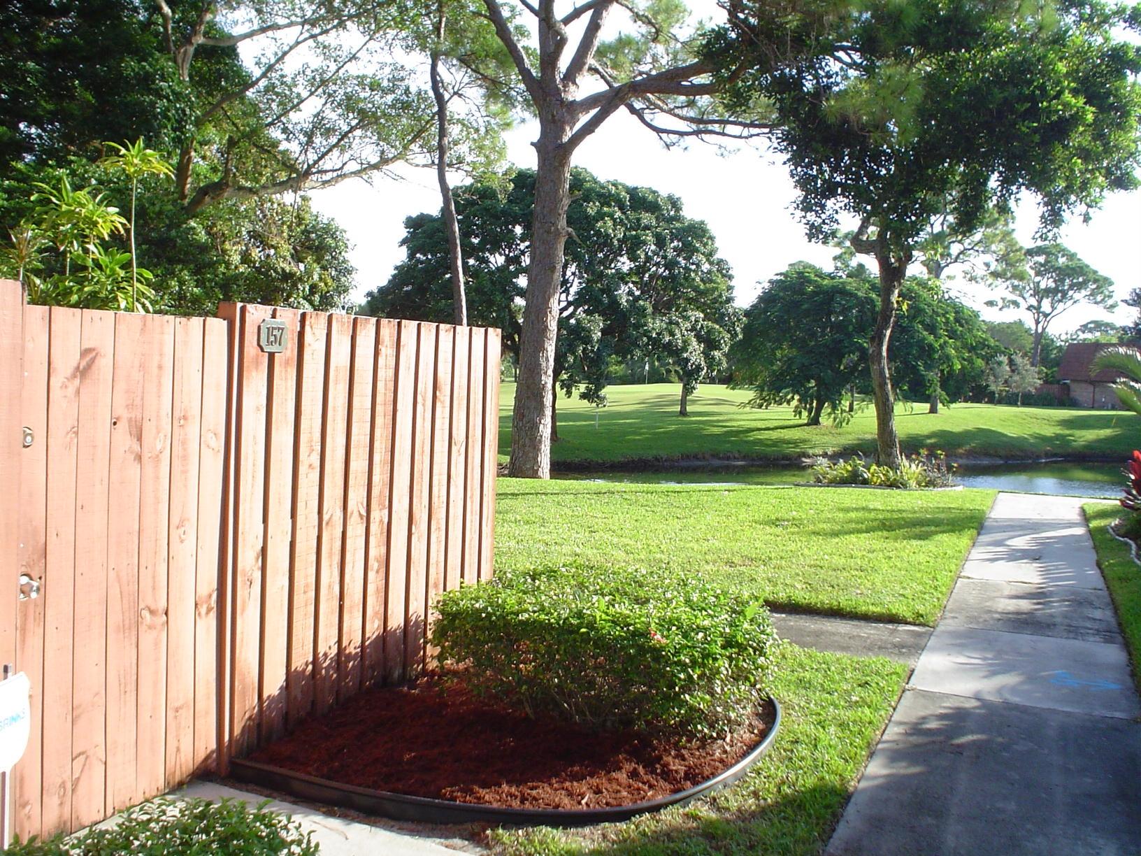 1445 Masters Circle, Unit 157 Delray Beach, FL 33445 - Photo 4 of 23 a view of a backyard with green space