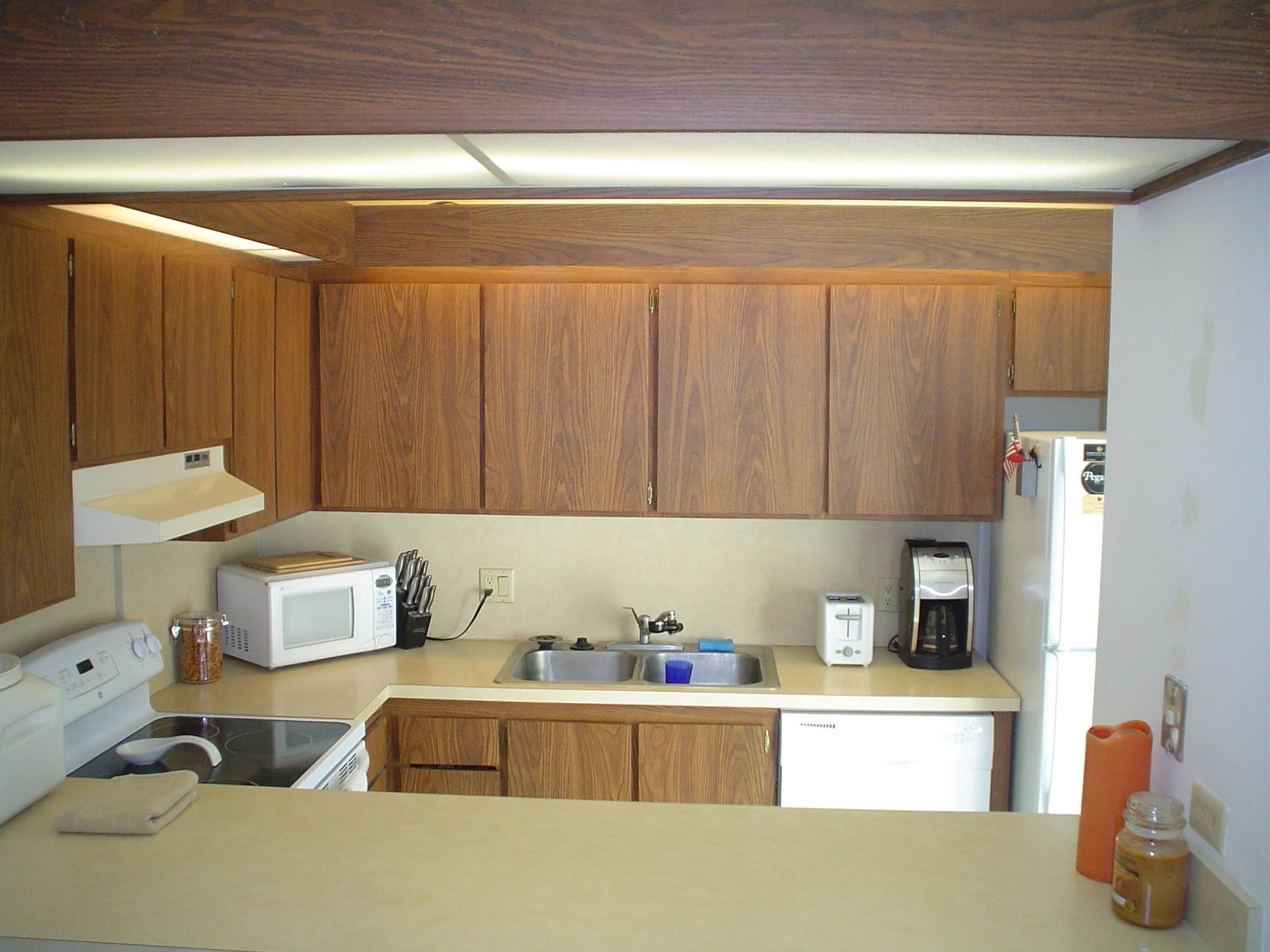 1445 Masters Circle, Unit 157 Delray Beach, FL 33445 - Photo 8 of 23 a kitchen with a sink and cabinets
