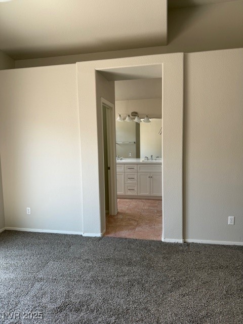 951 Country Back Road Las Vegas, NV 89123 - Photo 16 of 20 Unfurnished bedroom featuring light colored carpet, a sink, and baseboards