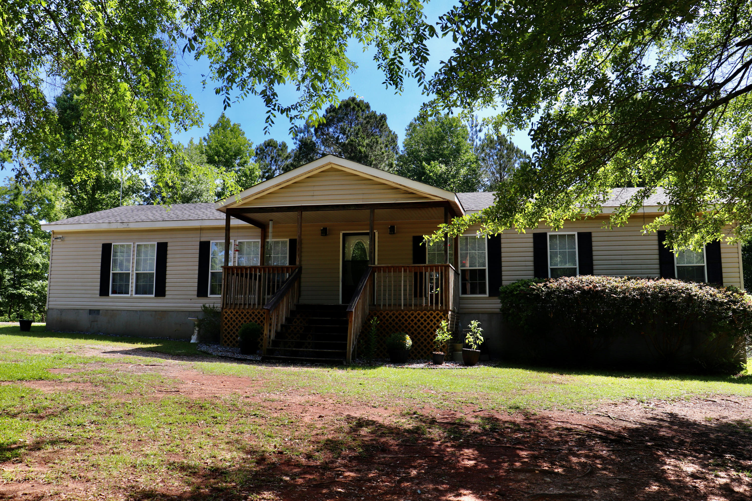213 Browns Crossing Road Northwest Haddock, GA 31033 - Photo 1 of 28 a front view of a house with a yard