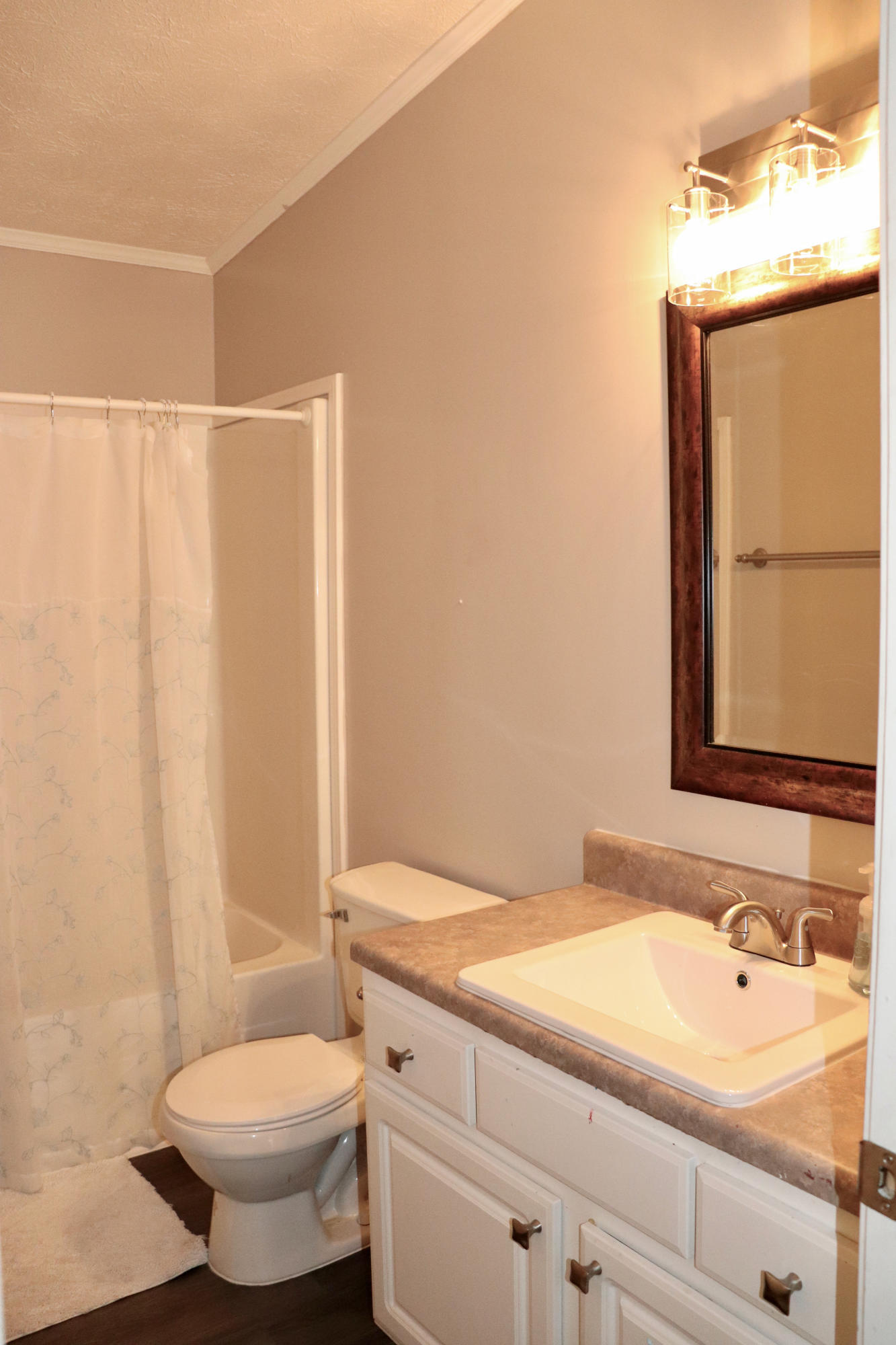 213 Browns Crossing Road Northwest Haddock, GA 31033 - Photo 23 of 28 a bathroom with a sink toilet and shower