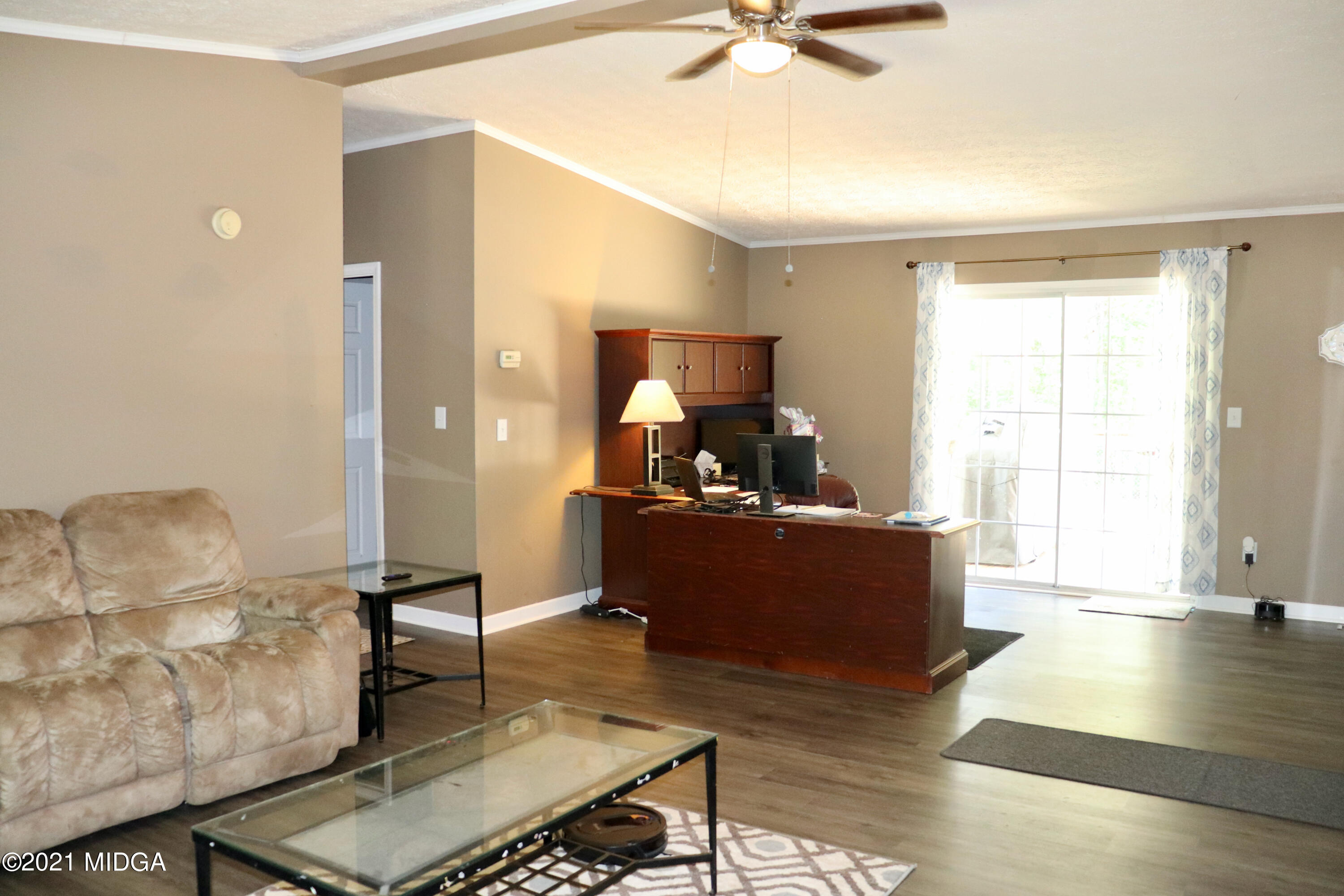 213 Browns Crossing Road Northwest Haddock, GA 31033 - Photo 6 of 28 a living room with furniture and a wooden floor