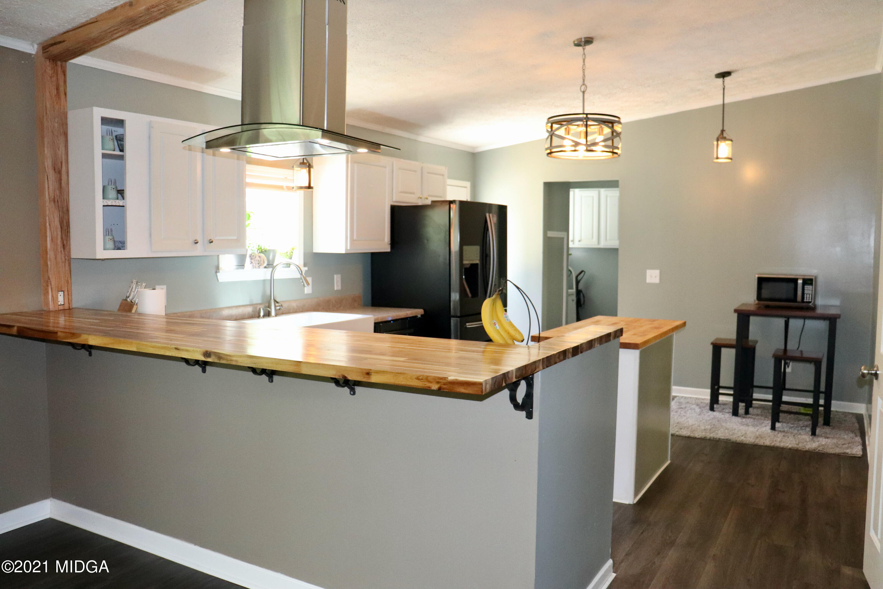 213 Browns Crossing Road Northwest Haddock, GA 31033 - Photo 9 of 28 a kitchen with stainless steel appliances granite countertop a sink a stove and a wooden floors