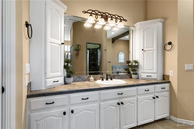 a bathroom with a double vanity sink and a mirror