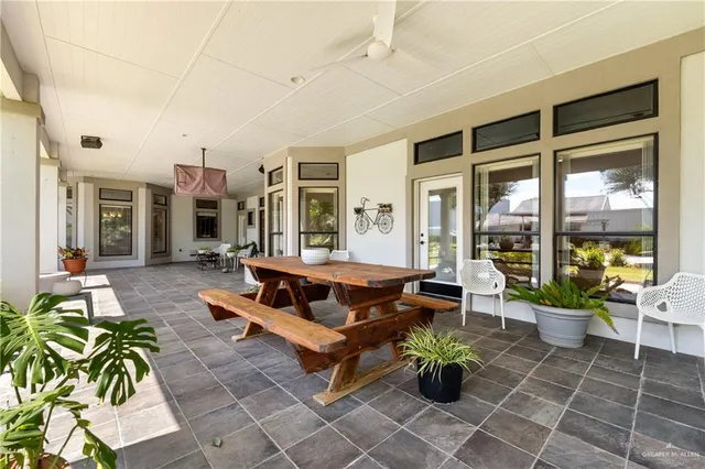 a living room with patio furniture and a potted plant
