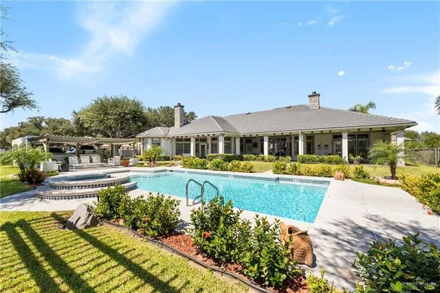 a front view of a house with swimming pool having outdoor seating