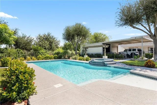 a view of a house with backyard and a tree