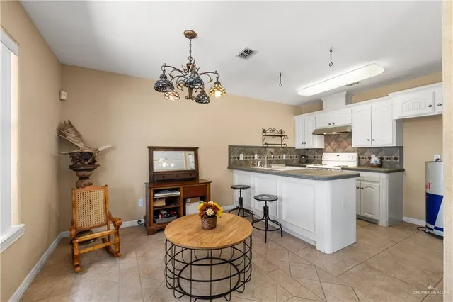 a bedroom with a bed and dresser with mirror