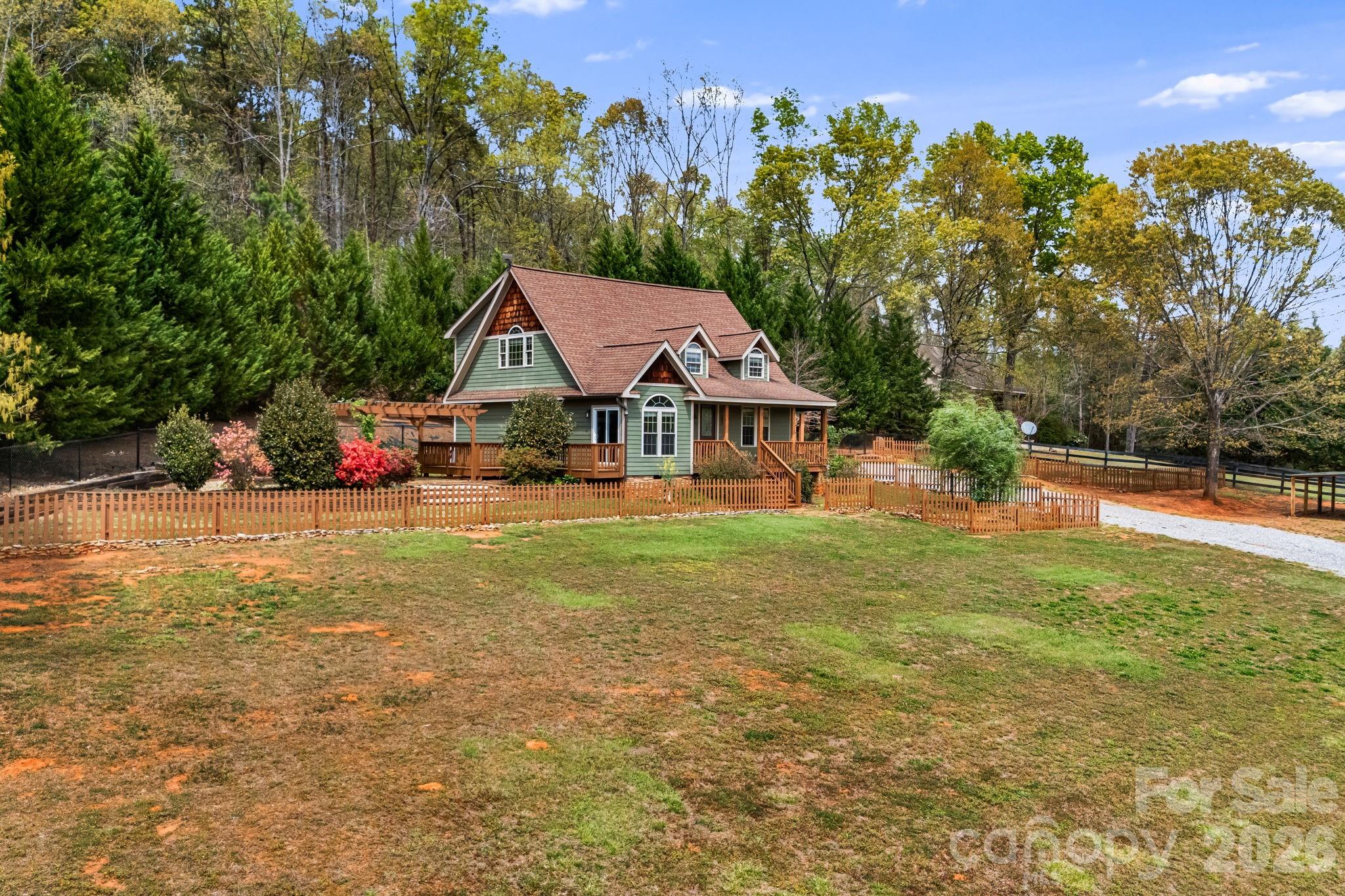 2011 Edgerton Road Mill Spring, NC 28756 - Photo 30 of 31 a view of house with garden space and trees in the background