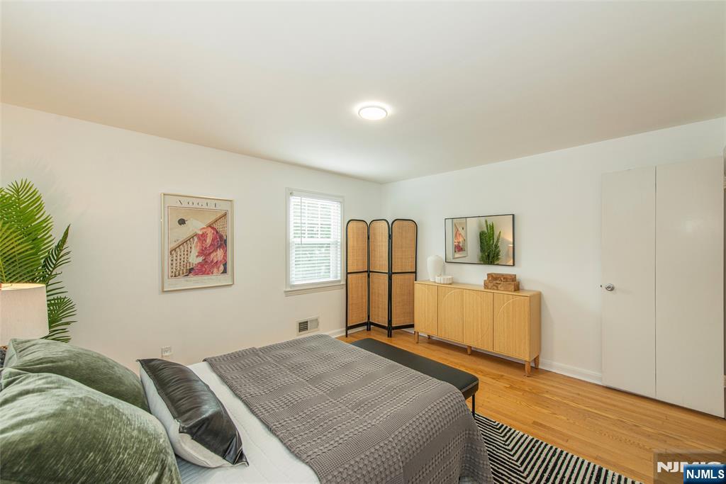 408 Washington Avenue Montclair, NJ 07042 - Photo 21 of 42 a bedroom with a bed and wooden floor