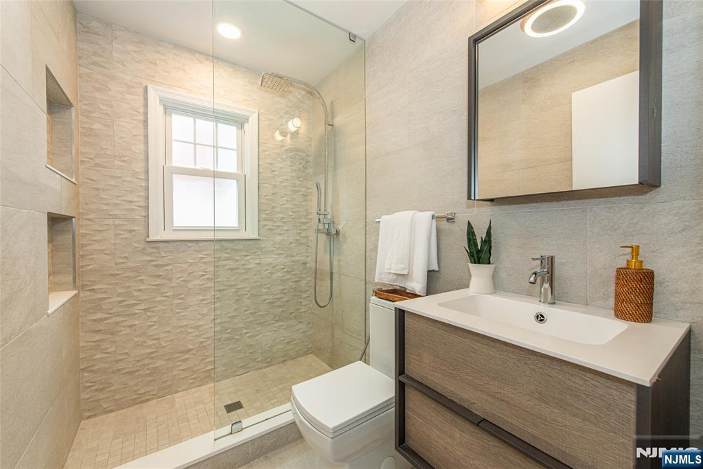 408 Washington Avenue Montclair, NJ 07042 - Photo 22 of 42 a bathroom with a sink a toilet and shower