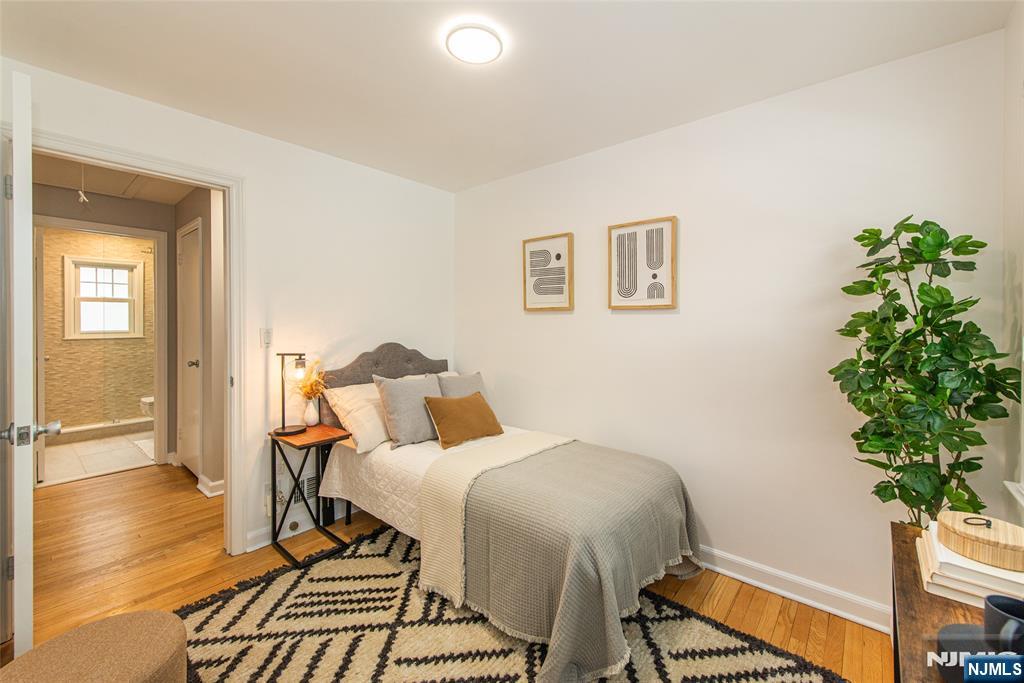 408 Washington Avenue Montclair, NJ 07042 - Photo 27 of 42 a bedroom with a bed and a potted plant
