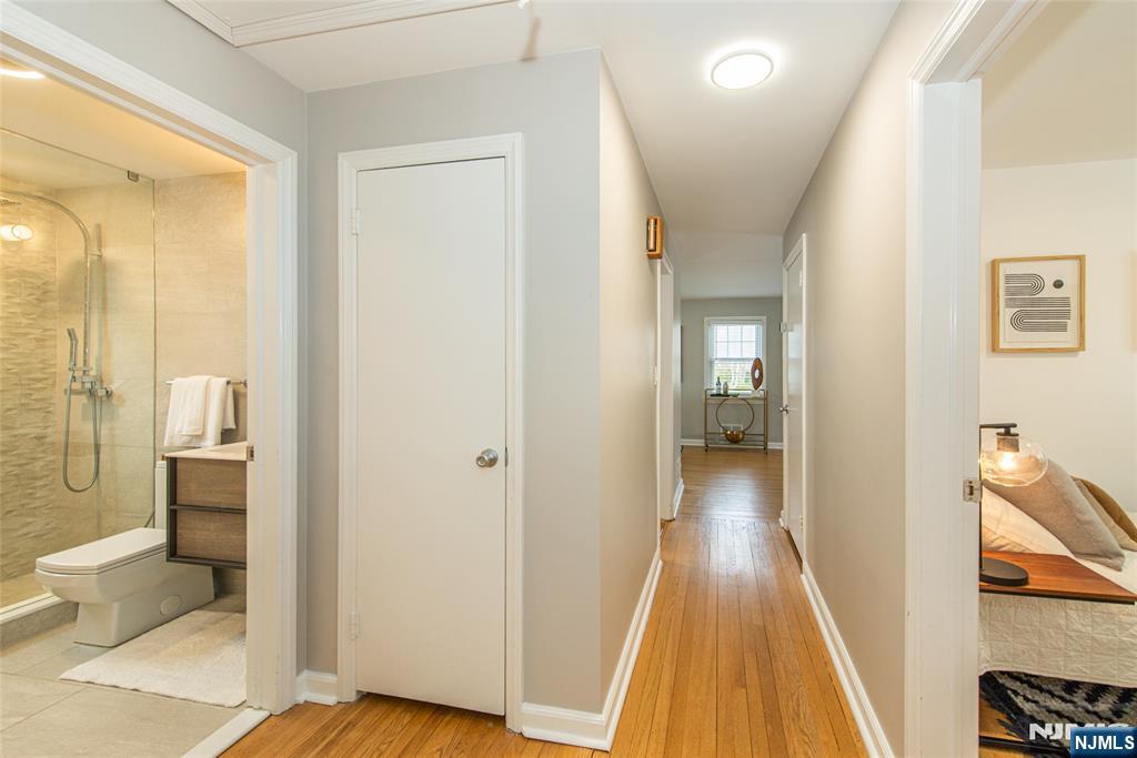 408 Washington Avenue Montclair, NJ 07042 - Photo 28 of 42 a view of a hallway with wooden floor and a bathroom