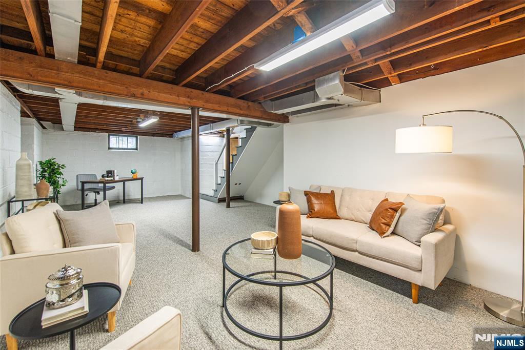 408 Washington Avenue Montclair, NJ 07042 - Photo 29 of 42 a living room with furniture and a chandelier