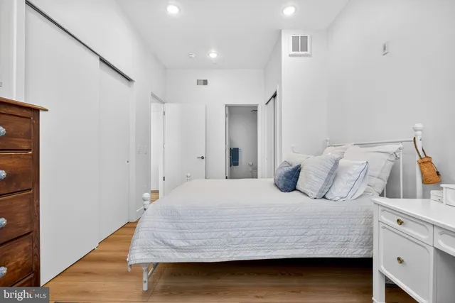 a bedroom with a bed and cabinet