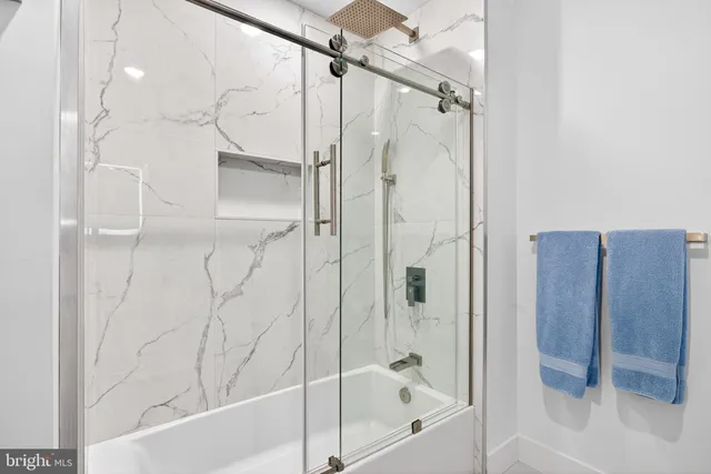 a bathroom with a bathtub and a shower