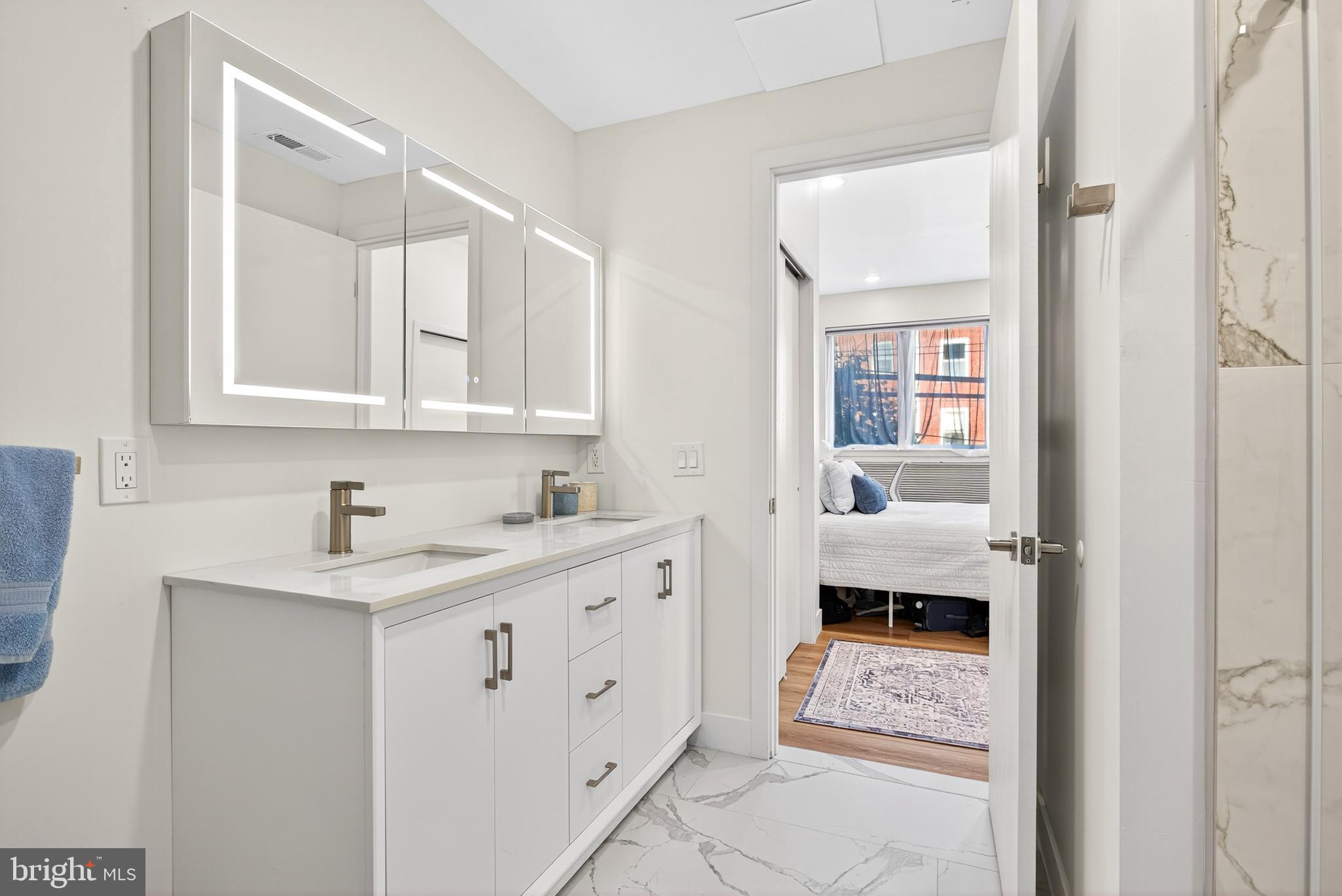 300 Christian Street, Unit 311 Philadelphia, PA 19147 - Photo 16 of 30 a en suite bathroom with a toilet sink and mirror
