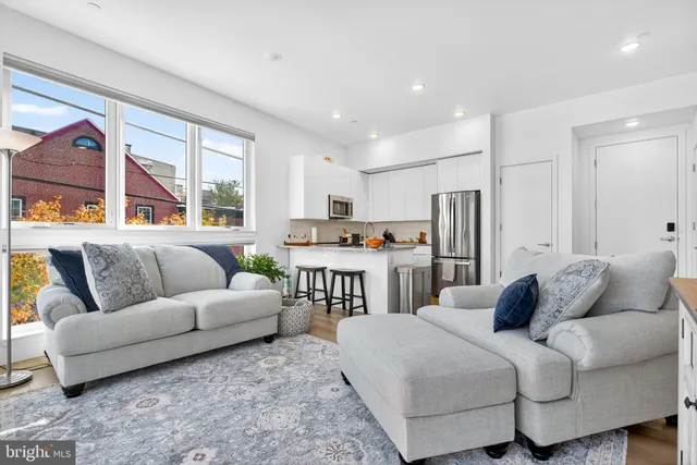 a living room with furniture and a large window