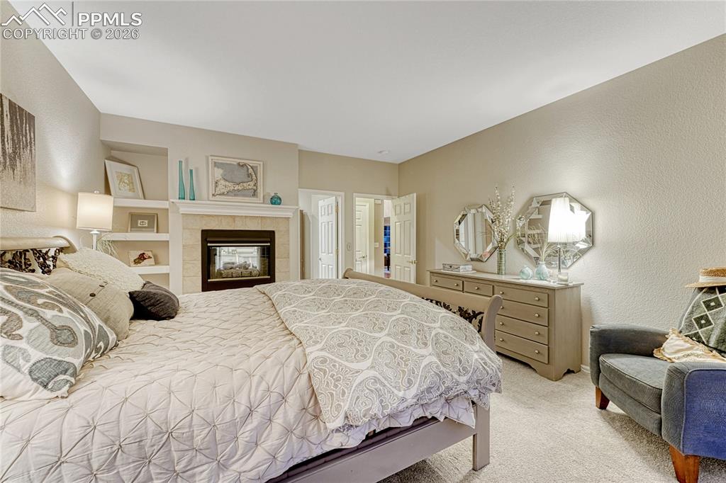 15585 Falcon Ridge Court Colorado Springs, CO 80921 - Photo 17 of 50 a bedroom with a bed and dresser with mirror