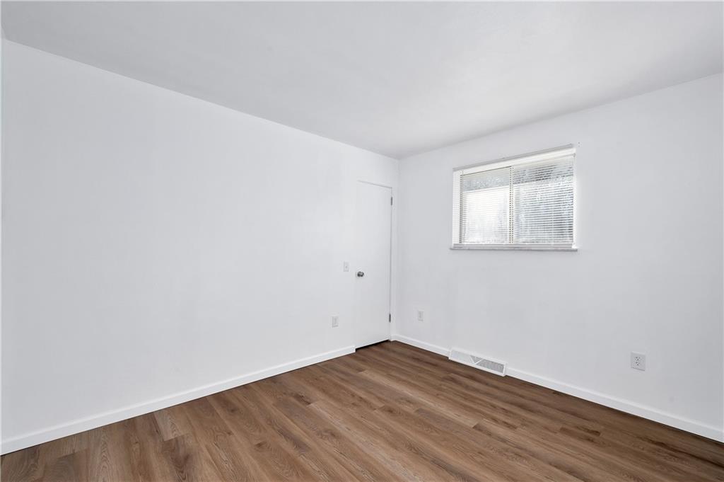 325 East Brewster Road Butler, PA 16001 - Photo 20 of 36 an empty room with wooden floor and windows