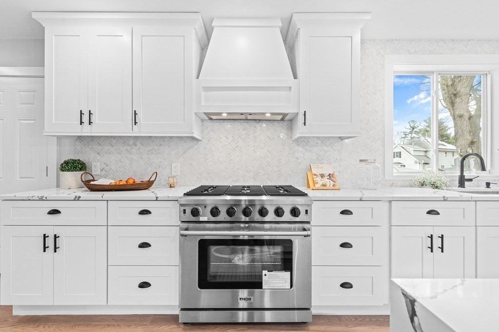 20 Mohawk Road Burlington, MA 01803 - Photo 11 of 39 a kitchen with white cabinets and white appliances