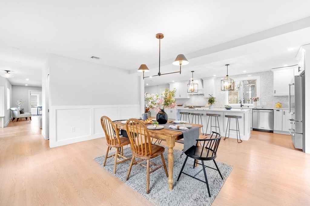 20 Mohawk Road Burlington, MA 01803 - Photo 16 of 39 a dining room with furniture and a kitchen view