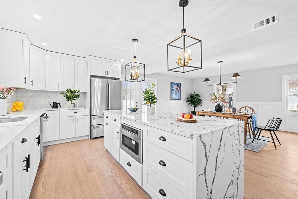20 Mohawk Road Burlington, MA 01803 - Photo 2 of 39 a kitchen with kitchen island white cabinets and white appliances