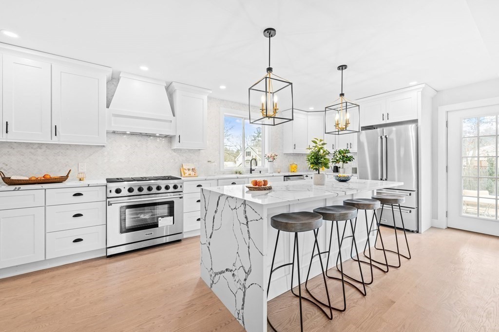 20 Mohawk Road Burlington, MA 01803 - Photo 3 of 39 a kitchen with stainless steel appliances kitchen island granite countertop a stove a sink and white cabinets
