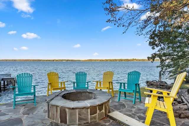 a view of a swimming pool with a patio and a yard