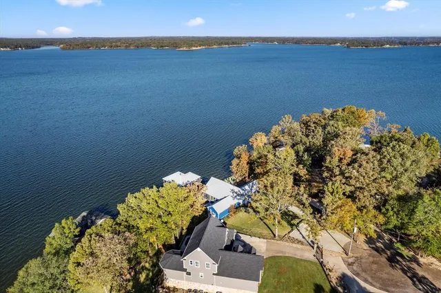 an aerial view of a house with a yard swimming pool and outdoor seating
