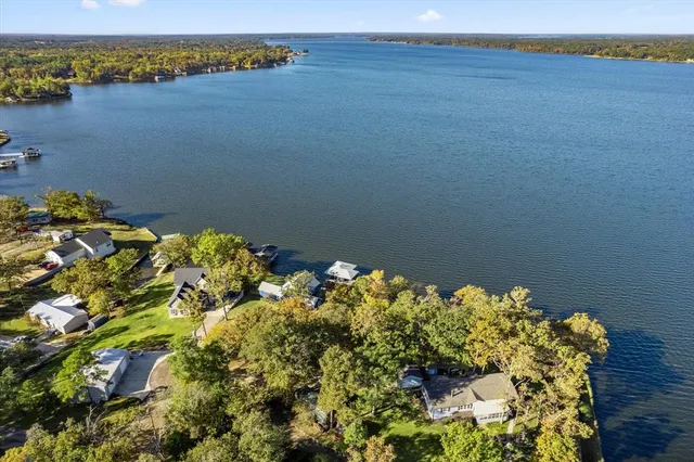 a living room with furniture ceiling fan and a large window