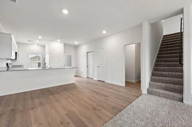 a view of kitchen with wooden floor and electronic appliances