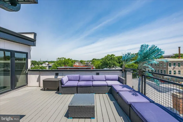 a view of deck with seating area and trees