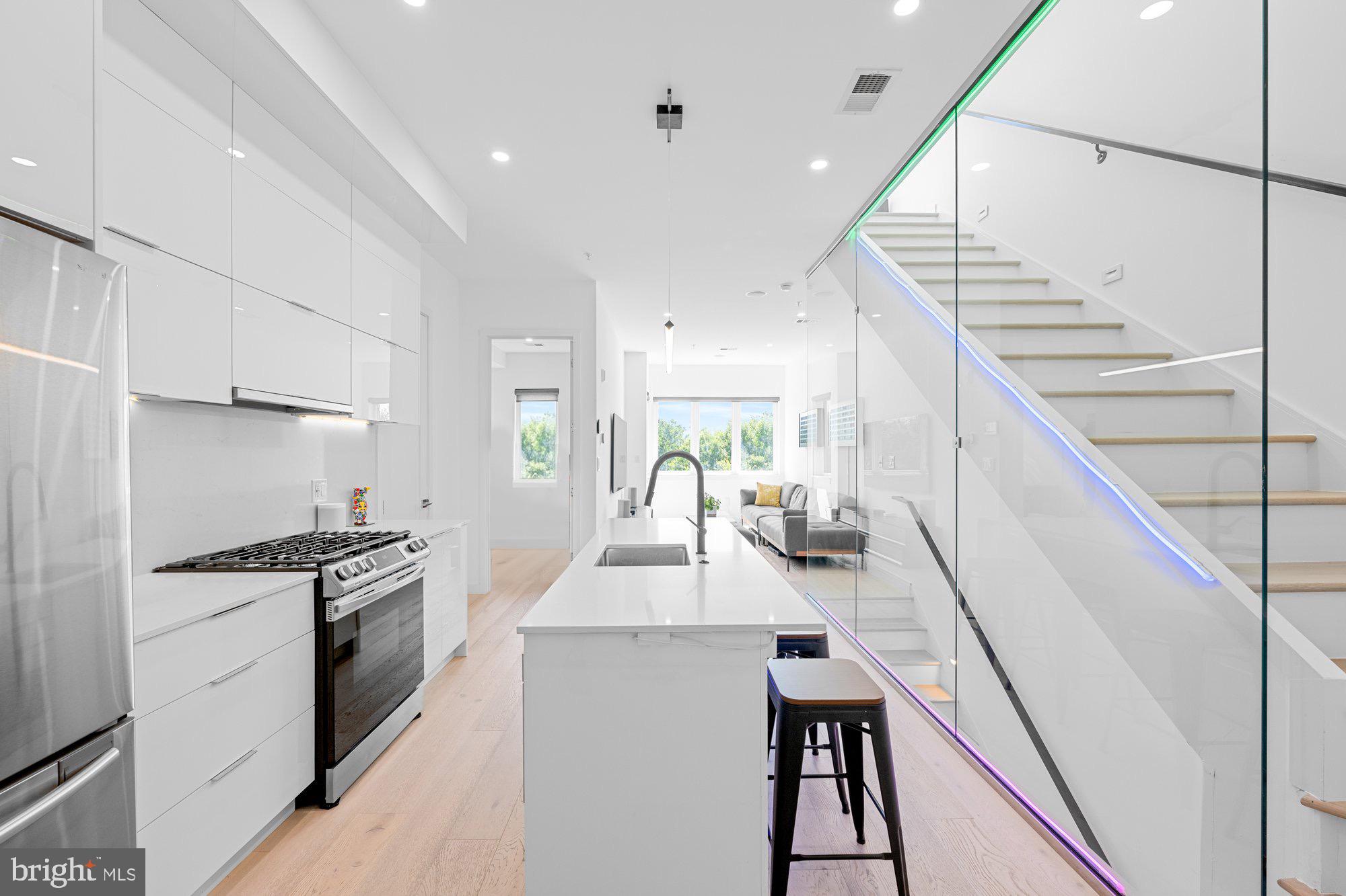 1715 North Capitol Street Northeast, Unit 7 Washington, DC 20002 - Photo 28 of 28 a kitchen with kitchen island white cabinets and stainless steel appliances