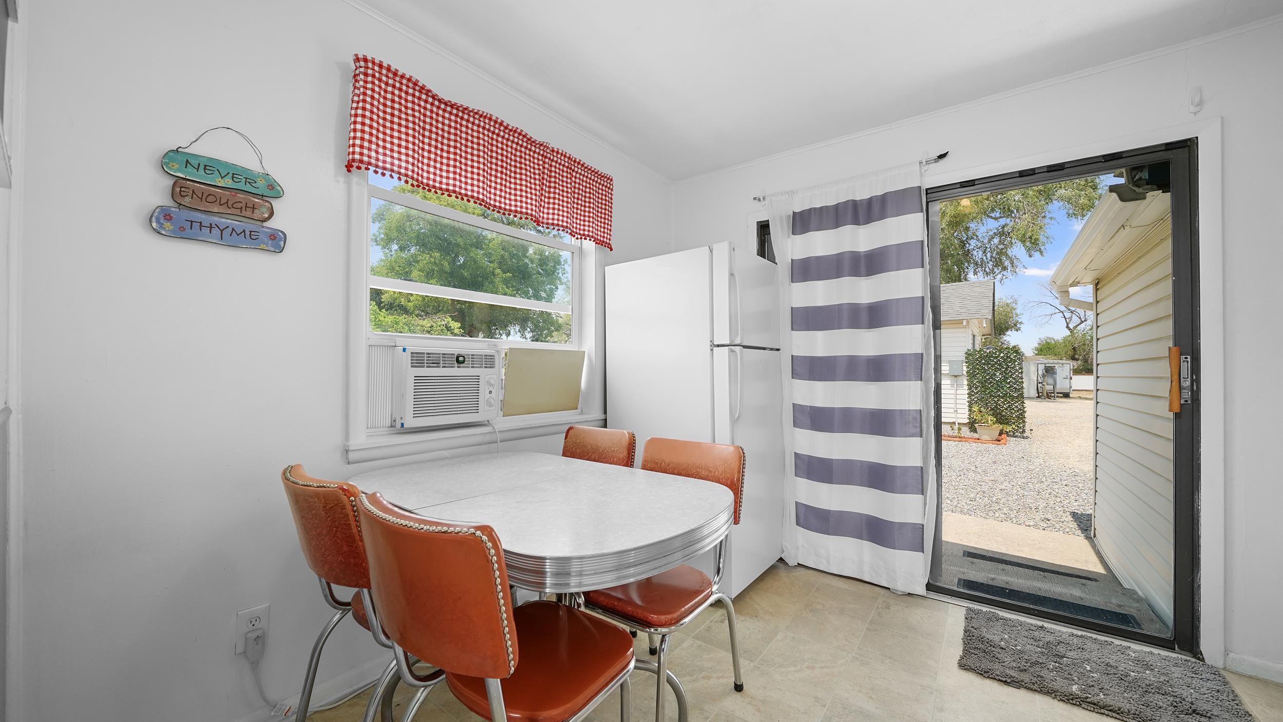 2396 H Road Grand Junction, CO 81505 - Photo 13 of 30 a dining room with furniture and a window