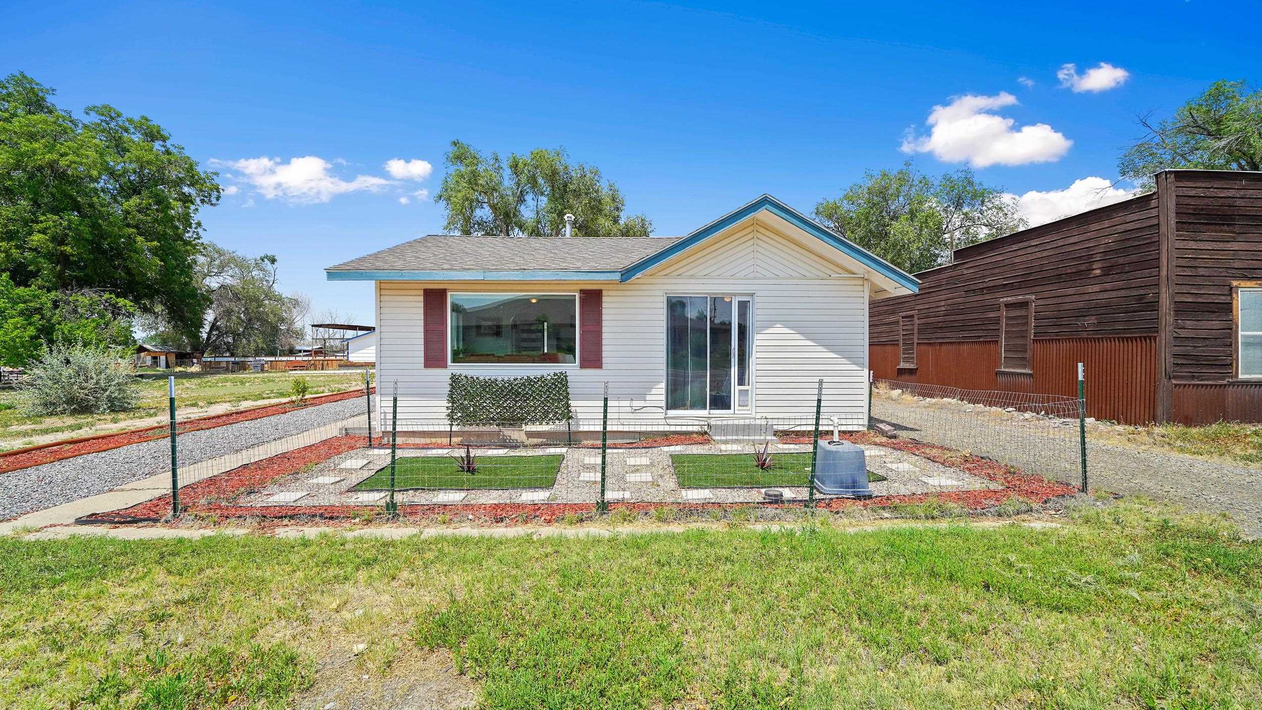 2396 H Road Grand Junction, CO 81505 - Photo 2 of 30 a view of a house with a yard and a large tree