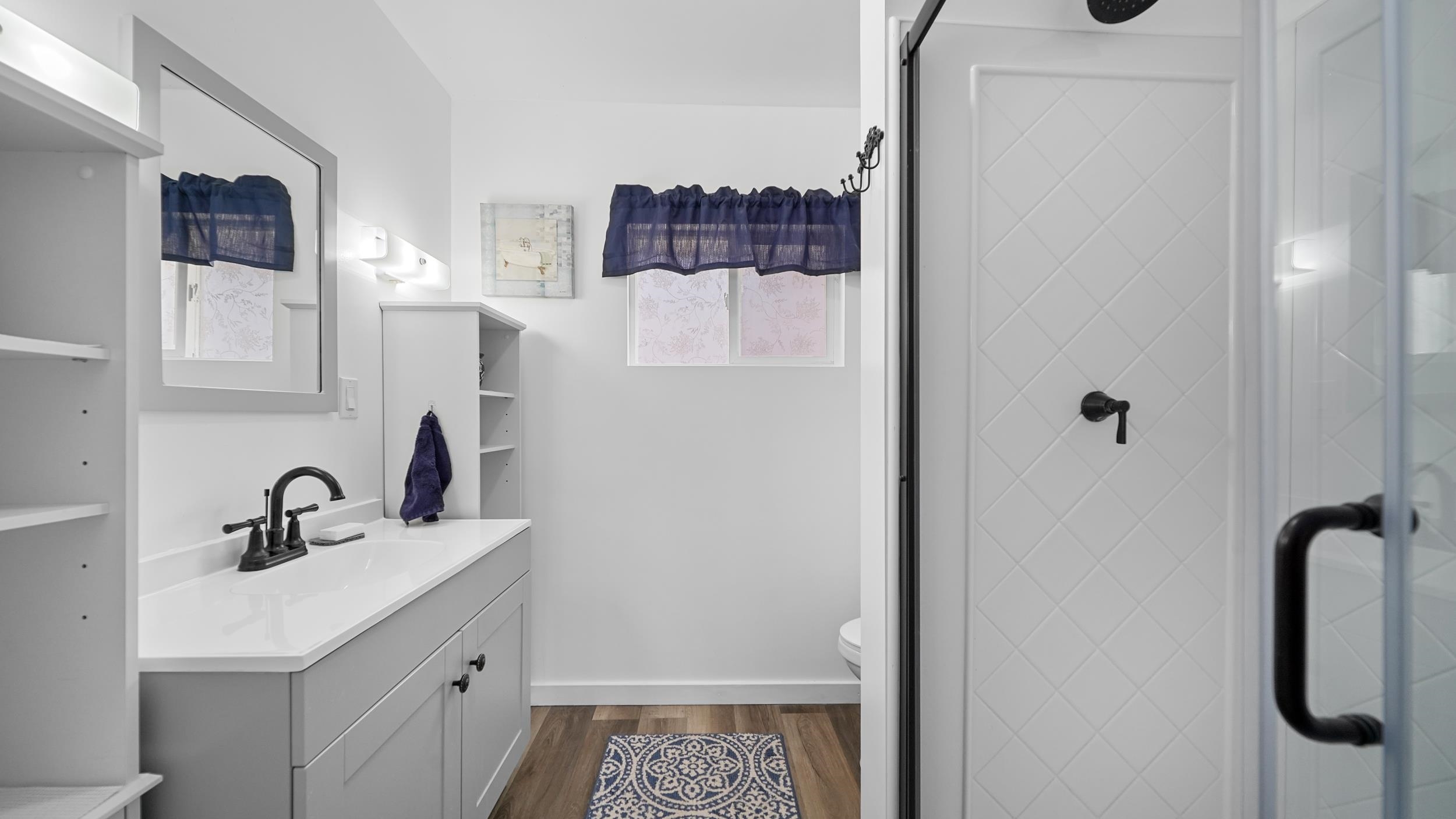2396 H Road Grand Junction, CO 81505 - Photo 7 of 30 a bathroom with a sink a mirror and shower