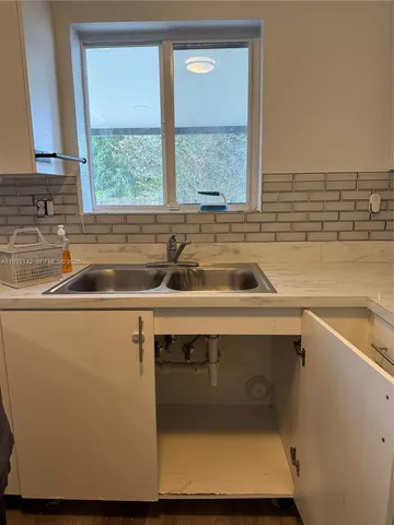 a kitchen with a sink and a window