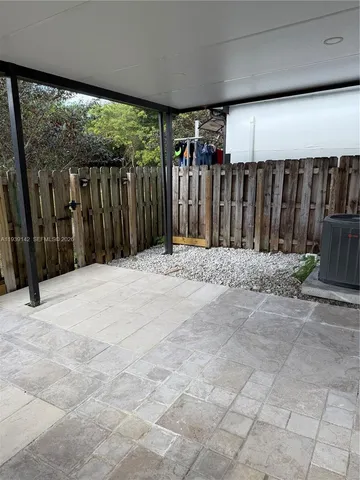 a view of small space with wooden fence