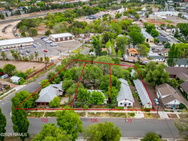 an aerial view of residential houses with outdoor space