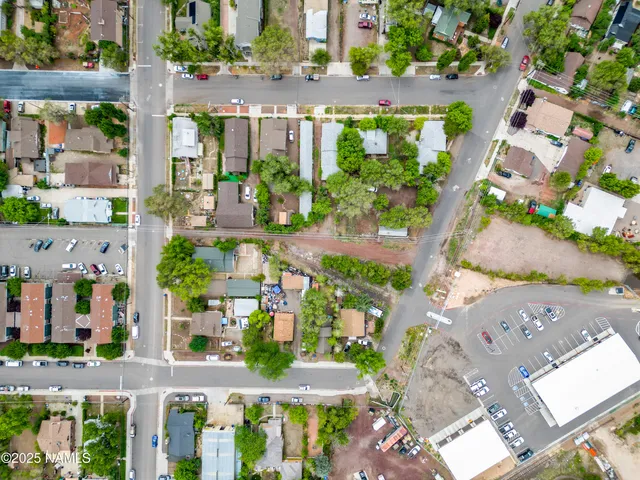 an aerial view of multiple houses with a yard