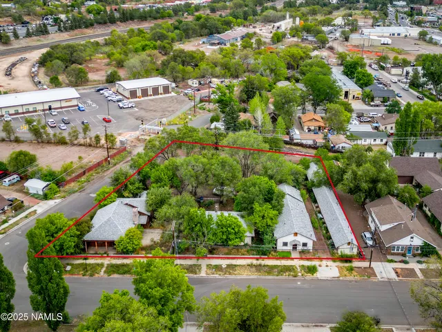 an aerial view of residential houses with outdoor space