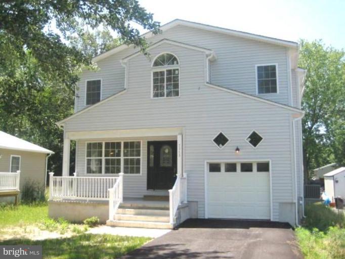 7313 Chesapeake Road Middle River, MD 21220 - Photo 1 of 1 a front view of a house with a yard