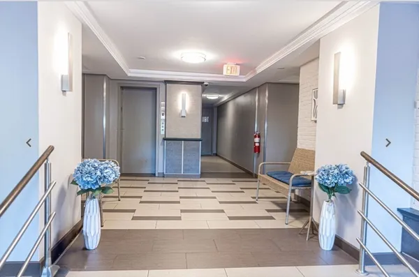 a living room with furniture and flowers